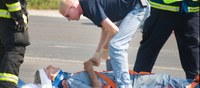 image of EMS worker helping injured person.