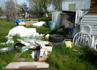 Code violation   yard littered messy overgrown grass