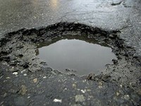 image of a pothole with water in it