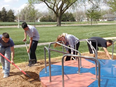 Community Service 2 members of the track team helping spread new wood chips in the play ground areas